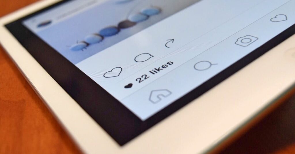 Photo of a tablet displaying a social media app interface with 22 likes, highlighting digital interaction.