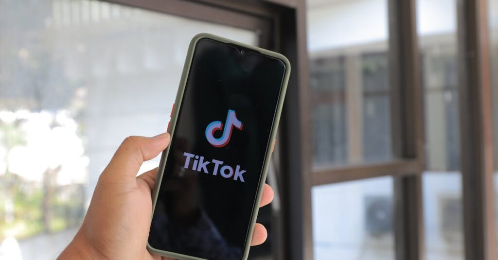 Close-up of a hand holding a smartphone displaying the TikTok app indoors.