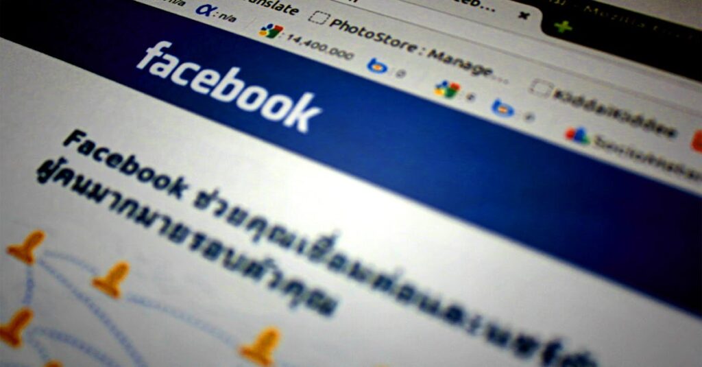 High-angle shot of the Facebook website homepage displayed on a computer screen in Thai language.