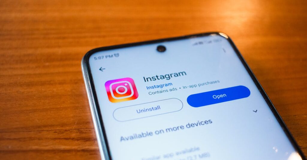 A smartphone displaying the Instagram app open option on a wooden table.