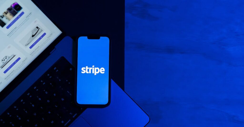 pexels-photo-29502368-29502368 A smartphone displaying the Stripe app placed on a laptop keyboard with a blue monochromatic tone.