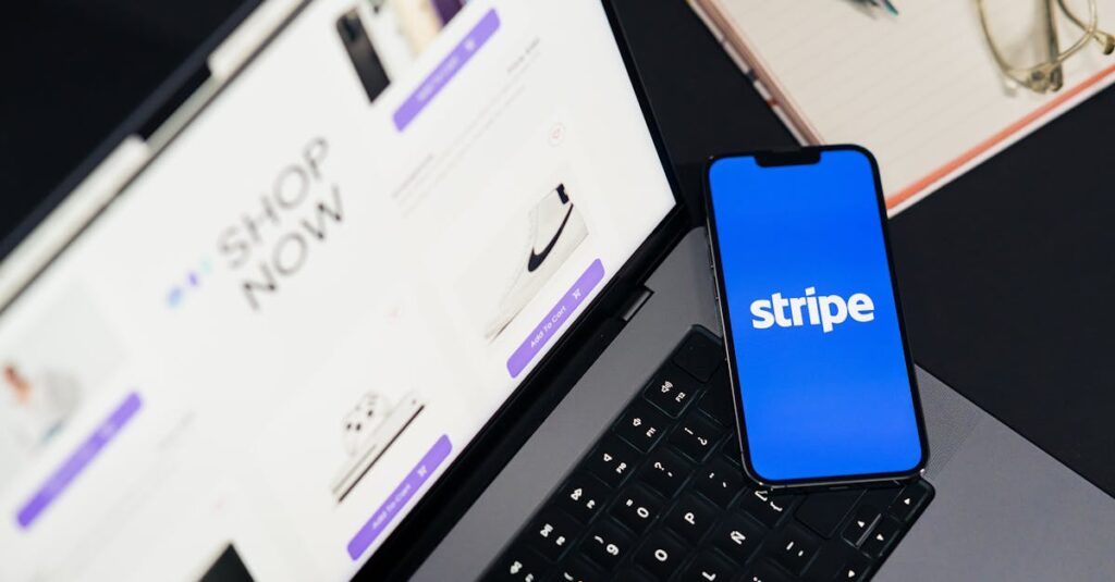 Mobile phone displaying Stripe app on a laptop with an eCommerce site open, symbolizing online shopping.